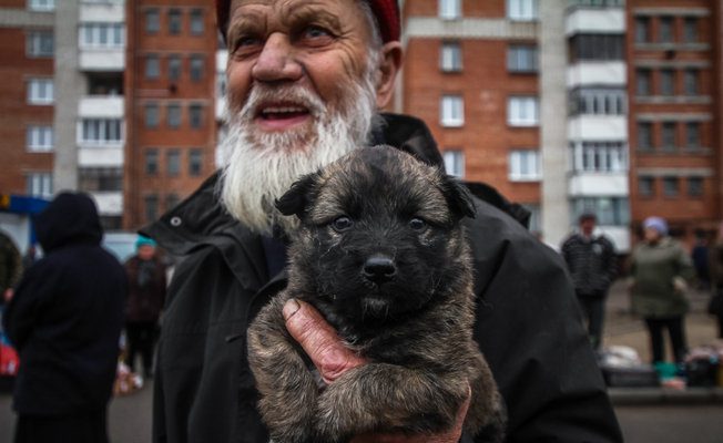 Мужчина продает щенка. Фото Сергей Гудилин. nn.by