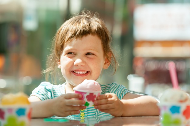 happy-3-years-girl-eating-ice-cream_1398-95